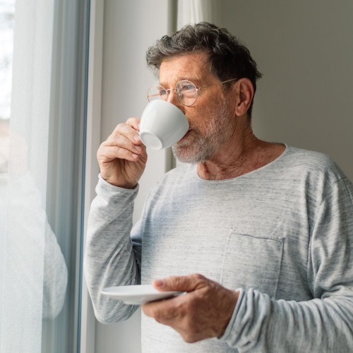 a man drinking from a cup