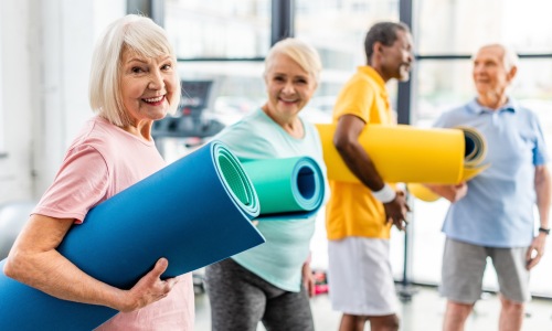 people holding yoga mats