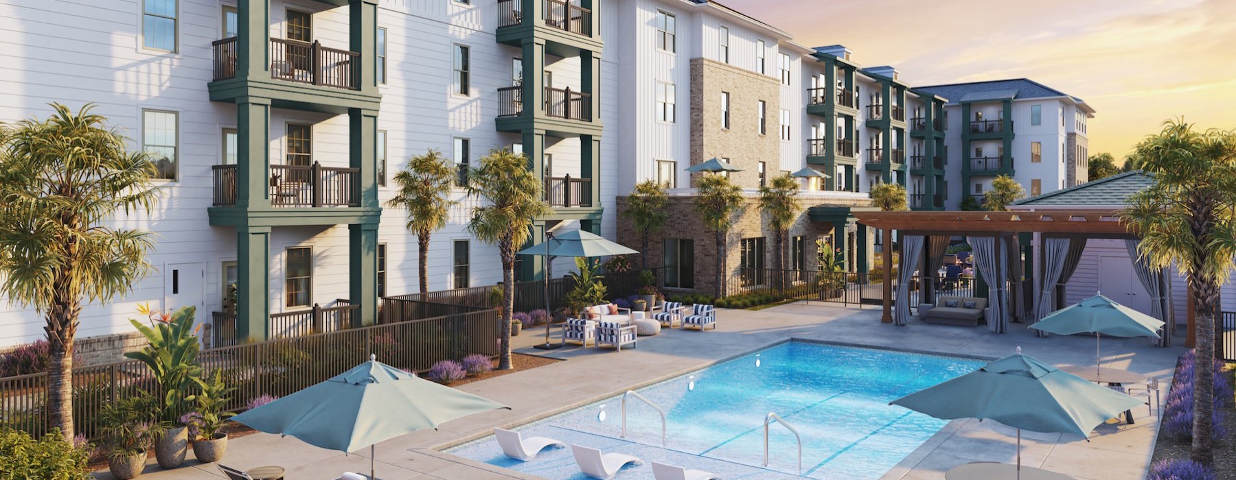 a pool with lounge chairs and umbrellas next to a building